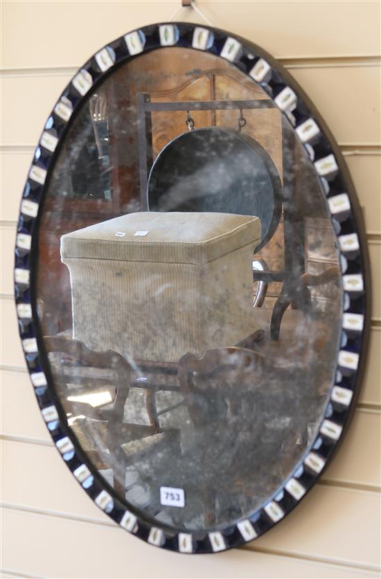 An Irish oval blue and clear glass framed wall mirror W.47cm